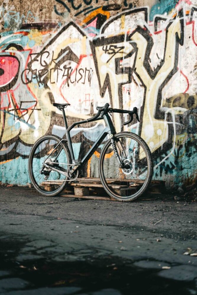 Gravel bike in front of graffiti wall