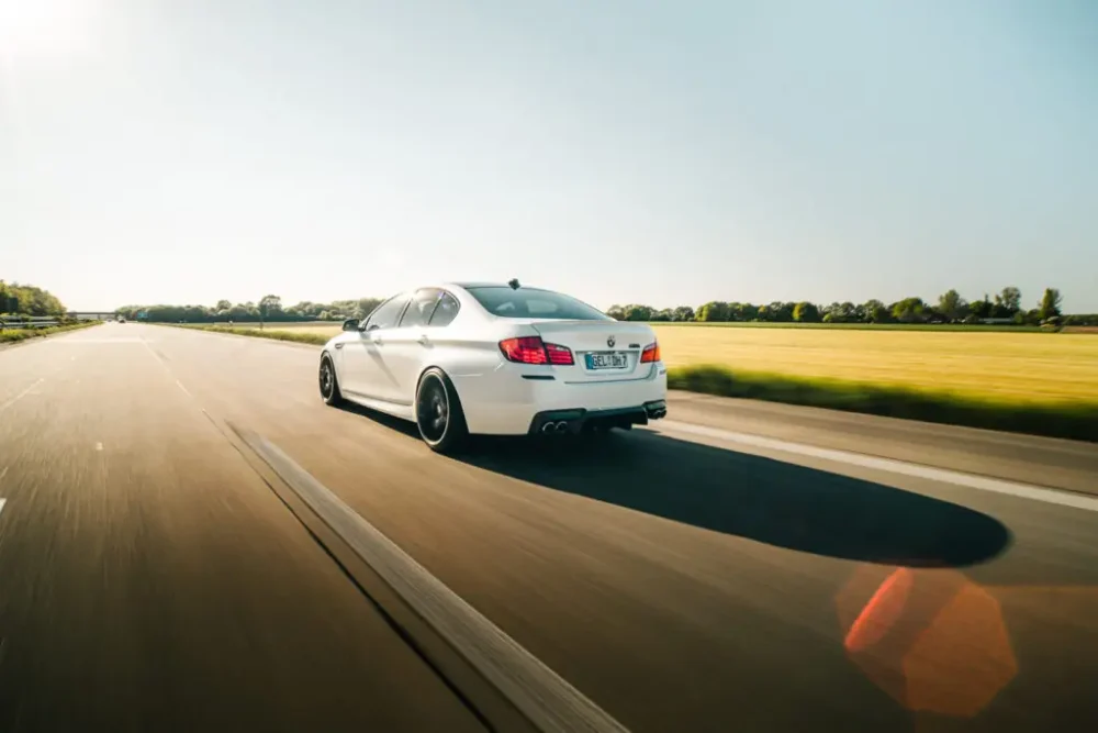 car driving fast in sunshine